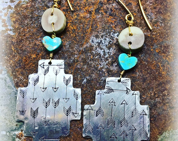 Arrow stamped Aztec patterns floating on nickel silver with bronze, antler and turquoise hearts add a very rustic charm to everyday wear