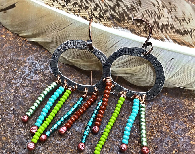 Fun oval sterling textured hoops with fun flashes of color from dropped rows of tiny seed beads, copper oxidized ear wires, urban chic