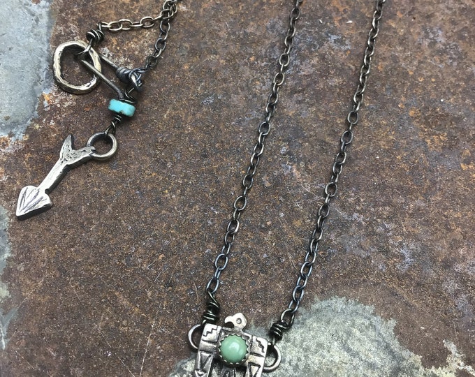 Itty bitty thunderbird necklace with tiny turquoise bezel set stone,sterling chain bronze hook and sterling arrow at closure