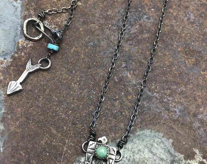 Itty bitty thunderbird necklace with tiny turquoise bezel set stone,sterling chain bronze hook and sterling arrow at closure