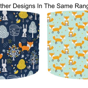 May include: Two fabric designs featuring woodland animals. The first design is a dark blue background with white rabbits, orange foxes, yellow trees, and white birds. The second design is a light blue background with orange foxes.