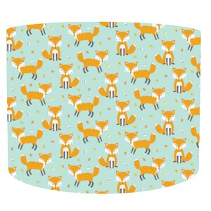 May include: A light blue lampshade with a repeating pattern of orange foxes on a light blue background.
