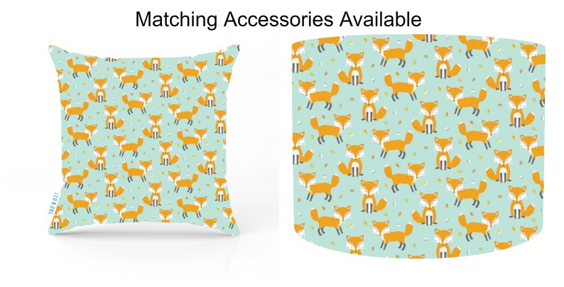 May include: A teal blue throw pillow with a repeating pattern of orange foxes and yellow leaves. The pillow is square and has a white border.