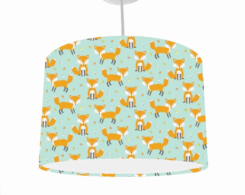 May include: A light blue lampshade with a repeating pattern of orange foxes on a light blue background.