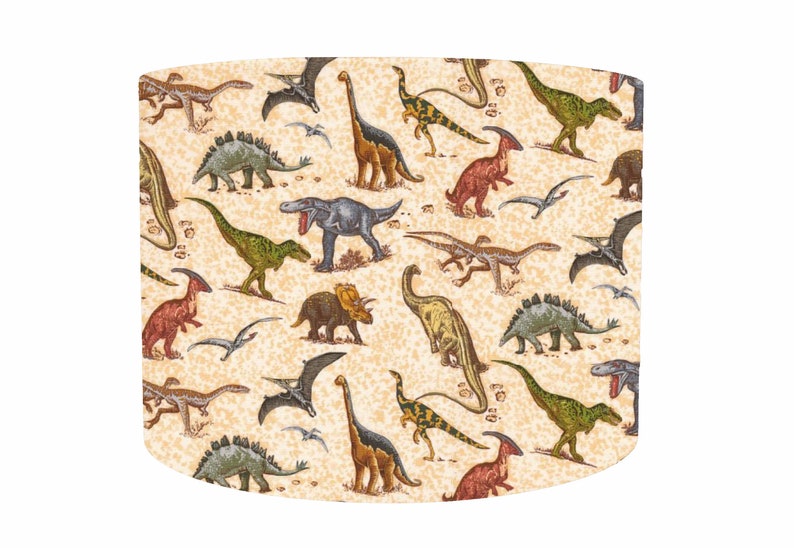 May include: A beige lampshade with a repeating pattern of colorful dinosaurs, including a Tyrannosaurus Rex, Triceratops, and Stegosaurus.