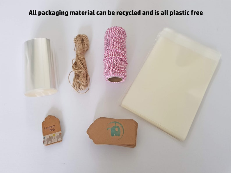 May include: A collection of packaging materials for gifts, including clear cellophane wrap, twine, brown paper gift tags, and a small bag. The text "Lavender Bag" is printed on one of the tags. All packaging materials are plastic-free and recyclable.