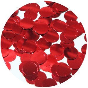 May include: A close-up image of a pile of red round sequins. The sequins are shiny and have a metallic finish.