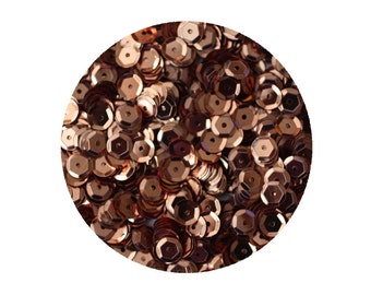 May include: A close-up of a pile of rose gold sequins. The sequins are small and round, with a slightly raised center. They are perfect for adding a touch of sparkle to any craft project.
