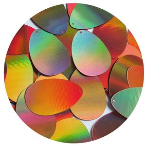 May include: Assortment of iridescent oval-shaped sequins in various shades of red, orange, yellow, green, blue, and purple. The sequins have a subtle shimmer and a slightly textured surface.