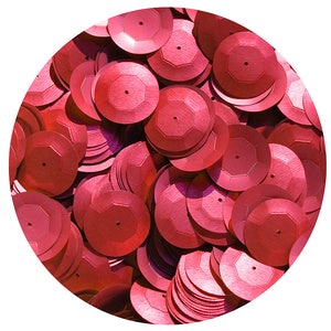 May include: A close-up of a pile of red sequins. The sequins are round and have a slightly raised center. They are perfect for adding sparkle to any craft project.
