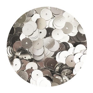 May include: A close-up image of a pile of silver sequins. The sequins are round and have a hole in the center. They are perfect for adding sparkle to crafts and clothing.