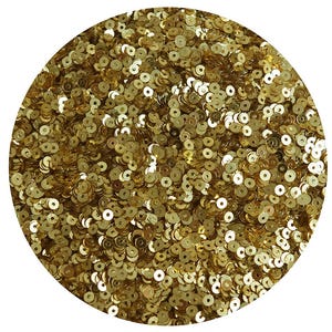 May include: A close-up of a large quantity of gold sequins. The sequins are small and round, and they are arranged in a random pattern.