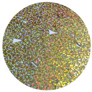 May include: A close-up of a collection of iridescent gold sequins. The sequins are round and have a glittery finish.