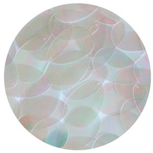 May include: A close-up of iridescent white oval sequins, arranged in a circular pattern. The sequins are translucent and have a subtle shimmer.