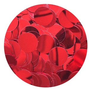 May include: A close-up image of a pile of red sequins. The sequins are round and have a shiny, metallic finish.