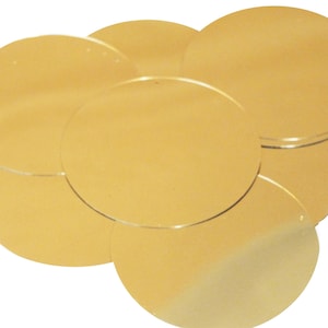 May include: A set of six gold-colored round paper circles. The circles are arranged in a overlapping pattern.