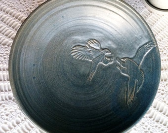 Ceramic plate signed dated 74 on the back of the plate with two fighting eagles sandstone style glaze finish