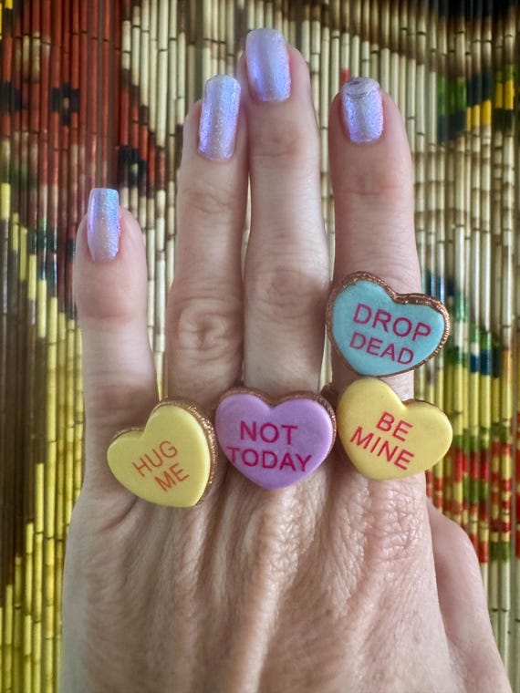Real conversation-heart candy electroformed in copper — wearable nostalgia with a punk twist, each one unique by nature of the process.