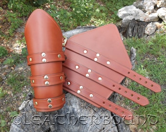 Leather Bracers in chestnut color with three straps.