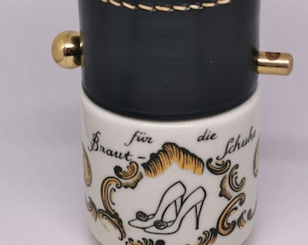 Bride's porcelain tip ("Trinkgeld") "Pfenning" jar hand made and painted with hard leather cover and brass pin, Germany (c. 1950s)