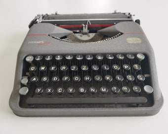 Hermes Baby Portable Typewriter in working condition with matching metal case, Switzerland (c. 1940)