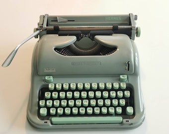 Hermes Media 3 Portable Typewriter in working condition with matching metal case