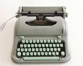 Hermes Media 3 Portable Typewriter in working condition with matching metal case, Switzerland (c. 1950)