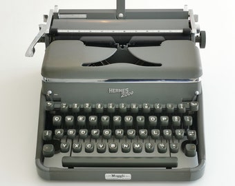 Hermes 2000 iconic portable typewriter from the 1960s in excellent working condition and gorgeous dark green color
