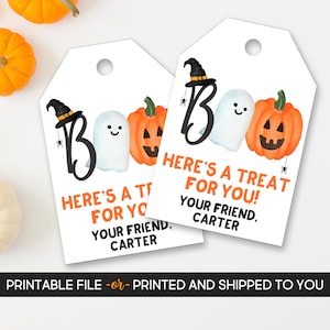 May include: Two white Halloween gift tags with a witch hat, ghost, and pumpkin design. The tags read "BOO" and "Here's a treat for you!" with the name "Carter". The tags have a hole at the top.