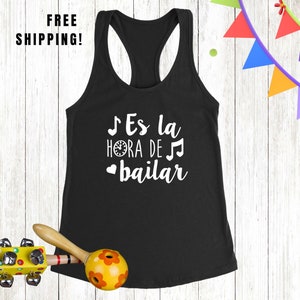 May include: Black tank top with white text that says "¡Es la hora de bailar" which translates to "It's time to dance".