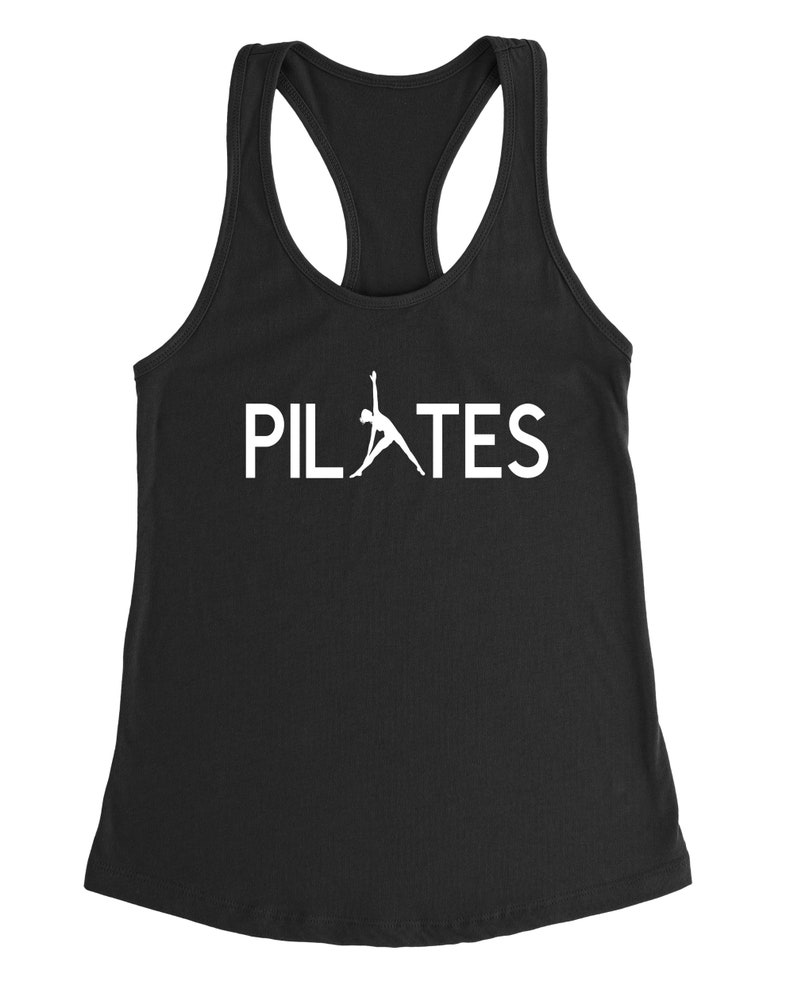 May include: Black tank top with a white silhouette of a person doing a pilates pose and the word "PILATES" in white text.