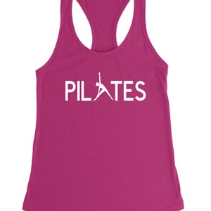 May include: A pink tank top with a white silhouette of a person doing a pilates pose and the word "PILATES" in white text.