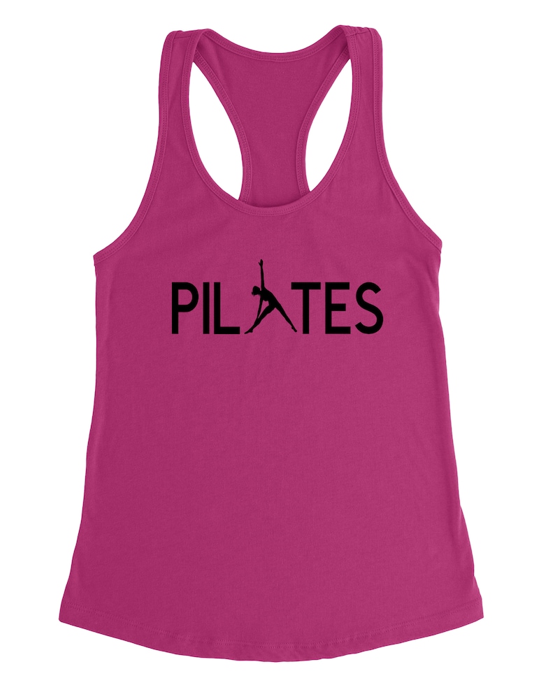 May include: A pink tank top with a black silhouette of a person doing pilates and the word "PILATES" in black text.