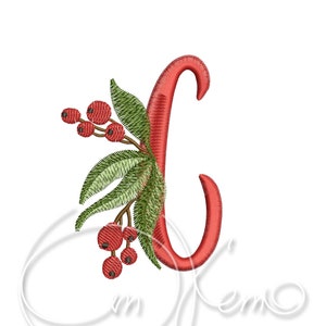 May include: Embroidered red letter "J" with a festive design. The letter is adorned with green leaves and red berries, creating a holiday or seasonal theme. The design is set against a clean white background.