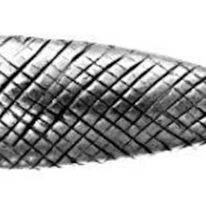 May include: A silver-colored, fish-shaped decorative object. The fish has a textured surface with a crosshatch pattern. The tail fin is small and curved.