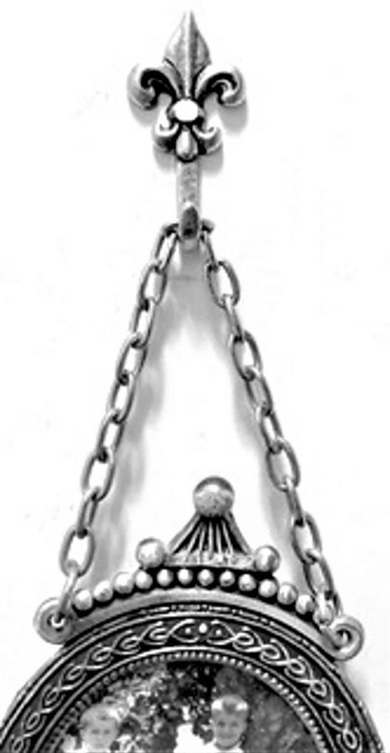 Mini silver fleur de lis hooks hanging a photo frame
