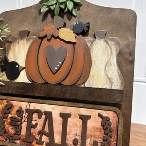 May include: Wooden autumn sign featuring a pumpkin, gourds, and birds. The sign reads "Hello Fall" in brown lettering.