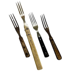 May include: Four vintage forks with wooden handles. The forks have a rustic, antique look and are made of metal with tines. The handles are made of wood and have a natural finish.