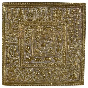 May include: A square brass plaque featuring a central circular mandala motif surrounded by concentric borders. The surface is densely decorated with embossed figures of various animals, stylized floral patterns, and geometric symbols in gold.