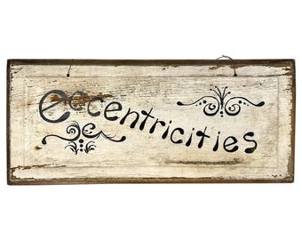 Letrero de arte popular primitivo pintado a mano con "excentricidades".