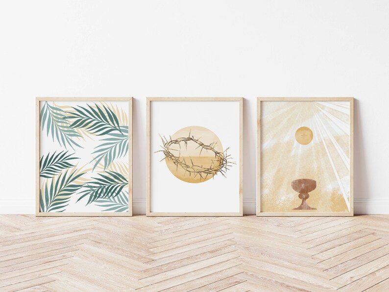 May include: Three framed prints with a religious theme. The first print features a pattern of green palm leaves on a white background. The second print features a brown crown of thorns on a yellow circle. The third print features a brown chalice with a yellow sun and rays of light behind it.