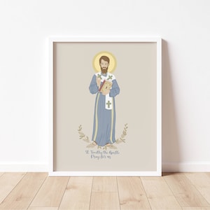 May include: A printable art print featuring a digital illustration of Saint Timothy, a Catholic saint. The image is in a light blue, beige, and brown color scheme. The text "St. Timothy the Apostle Pray for us" is at the bottom of the print.