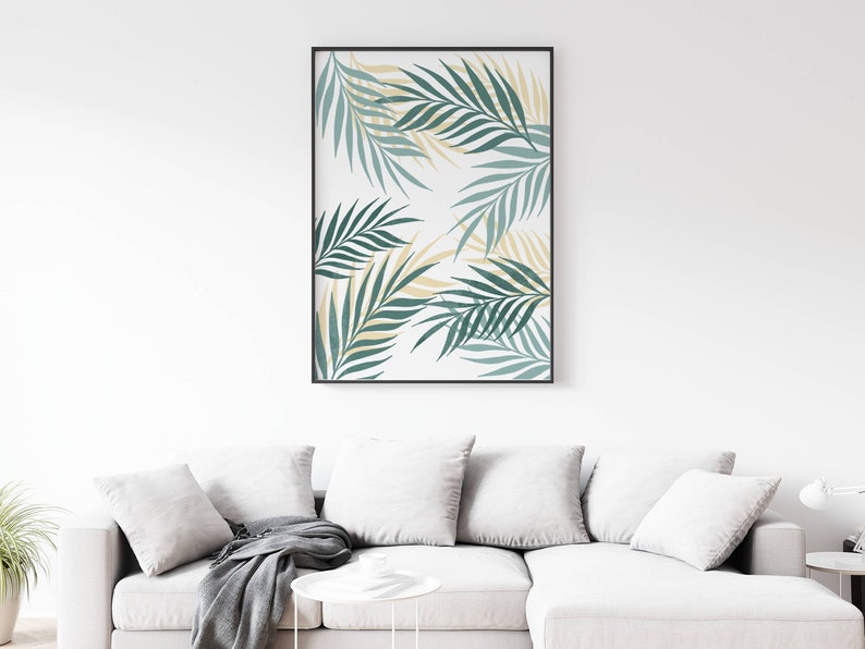 May include: A framed print with a white background and a pattern of green and yellow palm leaves.