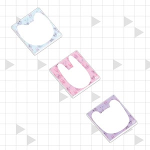 May include: Three square stickers with white animal shapes. The stickers have pastel backgrounds: light blue with a cat, pink with a bunny, and purple with a bear. Each sticker has a small design.