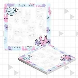 May include: A set of two square sticky note pads with a light blue and pink background. The background features a repeating pattern of white cartoon cat and bunny faces. The note pads have a white centre for writing notes. The text "RECKON & WONDER" is printed on the bottom of the note pad.