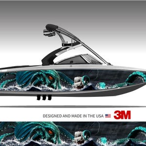 May include: A motorboat featuring a full-body vinyl wrap graphic of a large teal octopus with glowing red eyes emerging from dark ocean waves to attack a small white sailing ship. The text DESIGNED AND MADE IN THE USA is printed below.