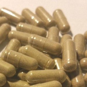 May include: A large pile of brown capsules, likely a dietary supplement or herbal remedy.