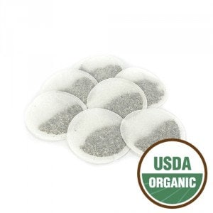 May include: A pack of ten round, white tea bags with a small amount of loose leaf tea visible inside each bag. The tea bags are arranged in a circle with the USDA Organic logo in the lower right corner.