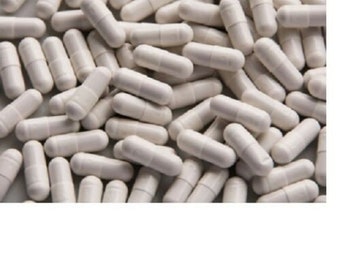 May include: A large pile of white capsules. The capsules are all the same size and shape, and they are arranged in a random pattern.