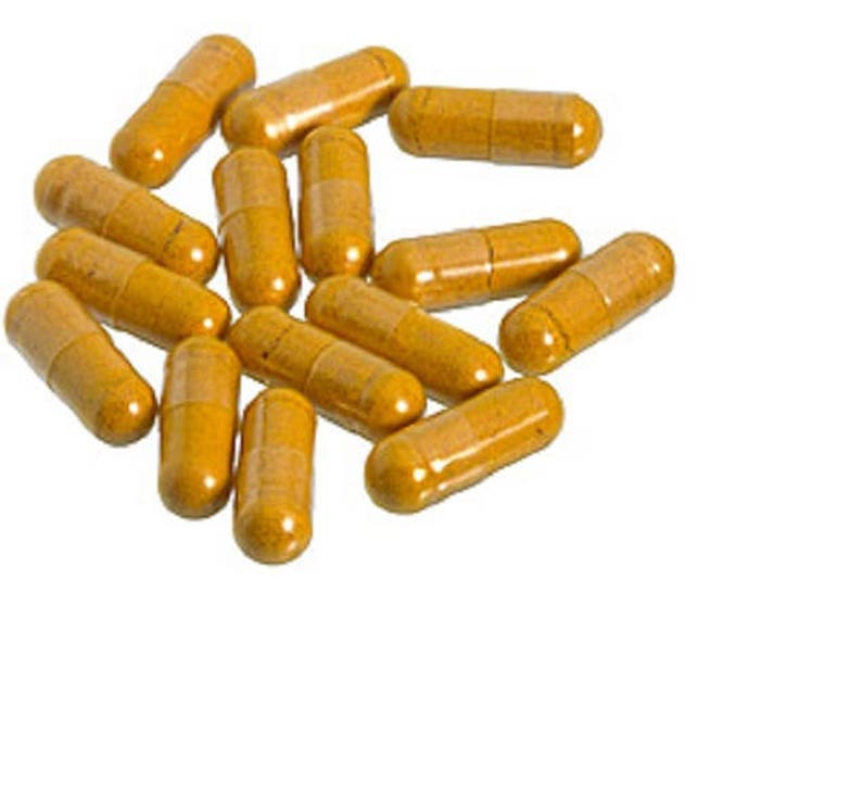 May include: A pile of yellow capsules, likely a dietary supplement or medication.